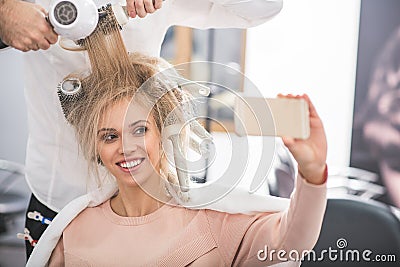 Happy woman is taking selfie Stock Photo