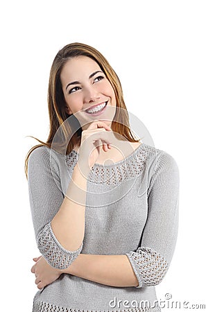 Happy woman thinking and looking sideways Stock Photo