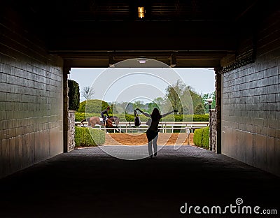 Happy Woman in Tunnel As Horse Runs Past Editorial Stock Photo