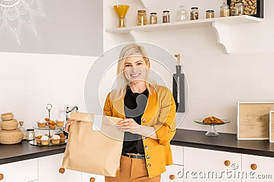 Happy Woman Unpacking On Line Purchase At Home Stock Photo