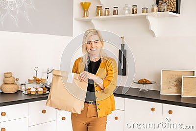 Happy Woman Unpacking On Line Purchase At Home Stock Photo