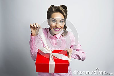 Happy woman unpacks gift Stock Photo