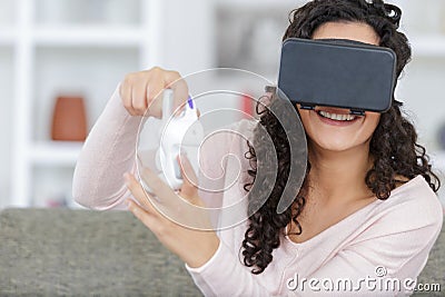 happy woman with virtual reality headset and joystick Stock Photo