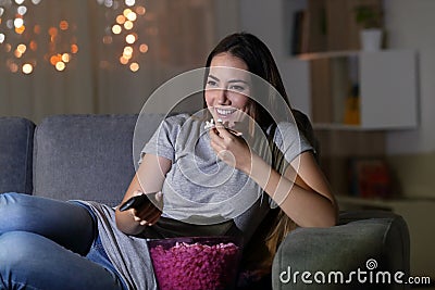 Happy woman watching tv in the night at home Stock Photo