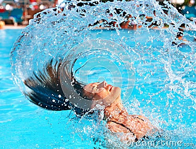 Happy woman in water waving hair Stock Photo