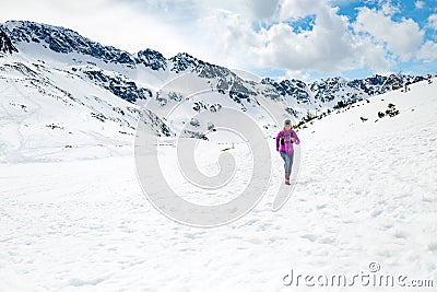 Happy woman winter trail running in beautiful inspirational land Stock Photo
