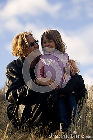 Happy woman with young girl in sun Stock Photo