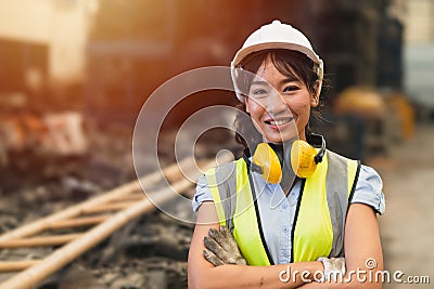 Happy women engineer Asian worker female work in factory portrait smile standing arm fold confidence look Stock Photo