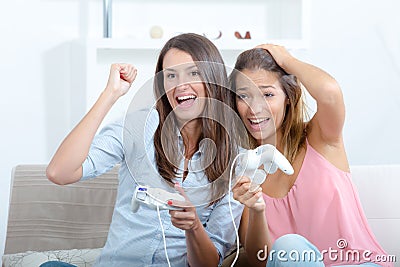 Happy women with joystick playing video games Stock Photo