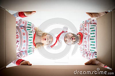 Surprised couple unpack Christmas gift box Stock Photo