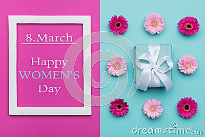 Happy Women`s Day Pastel Candy Colours Background. Floral womens day flat lay with beautifully wrapped present. Stock Photo