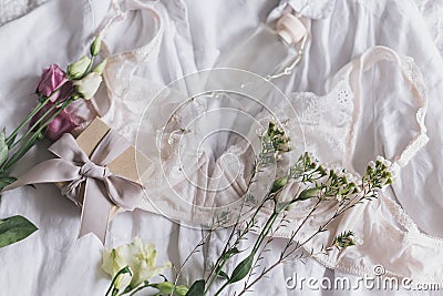 Happy Women`s day. Stylish lingerie,jewelry, gift, perfume and spring flowers. Soft trendy image Stock Photo