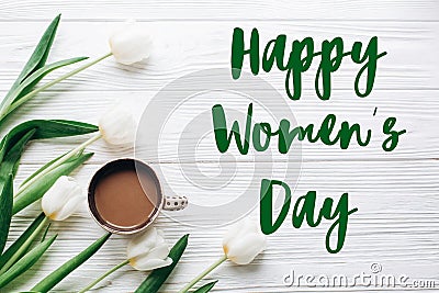 Happy womens day text sign on tulips and coffee on white wooden Stock Photo