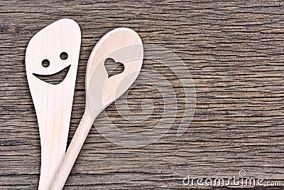 Happy wooden spoons on rustic table Stock Photo