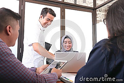 Multiethnic group of happy business people working together with laptop and tablet Stock Photo