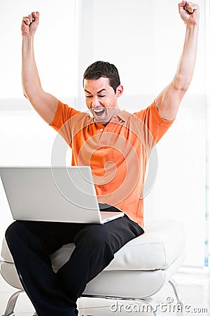 Happy work at home male working on laptop smiling Stock Photo