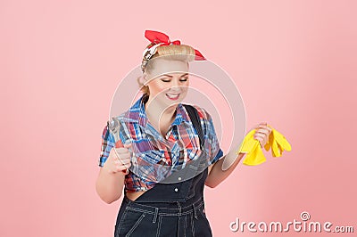 Happy worker girl with wrench and gloves. Teeth smiling woman ready to repair. Pin-up styled blonde girl with instruments Stock Photo