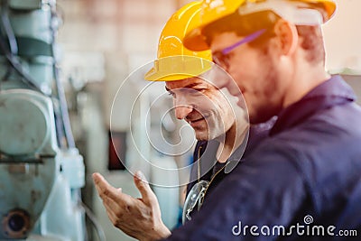 Happy worker, smiling industrial technician engineer enjoy working together with coworker Stock Photo