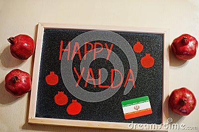Happy Yalda night. Iranian traditional holiday. Pomegranate inscription on blackboard, flat lay Stock Photo