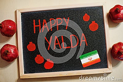 Happy Yalda night. Iranian traditional holiday. Pomegranate inscription on blackboard, flat lay Stock Photo