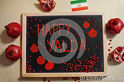Happy Yalda night. Iranian traditional holiday. Pomegranate inscription on blackboard, flat lay Stock Photo