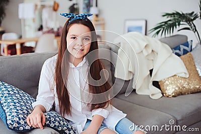 happy 10 years old kid or preteen girl relaxing at home Stock Photo