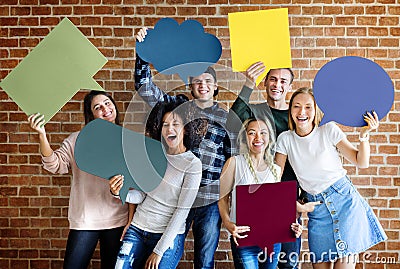 Happy young adults holding empty placard thought bubbles copyspa Stock Photo