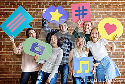 Happy young adults holding thought bubble with social medai concept icons Stock Photo