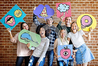 Happy young adults holding thought bubbles Stock Photo