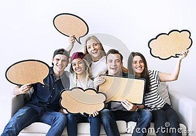 Happy young adults holding up copyspace placard thought bubbles Stock Photo