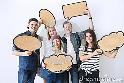 Happy young adults holding up copyspace placard thought bubbles Stock Photo