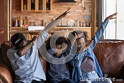 Smiling biracial parents with daughter dab dance Stock Photo