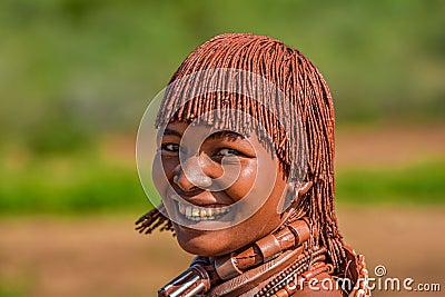 Happy young African female in a traditional headdress and body paint from the Ethiopian Hamer tribe Editorial Stock Photo