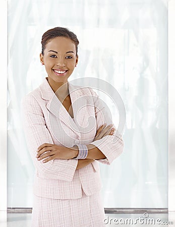 Happy young afro-american woman in office lobby Stock Photo