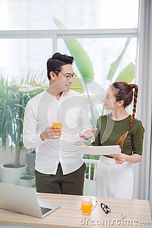 Happy young asian couple making organic drink together Stock Photo