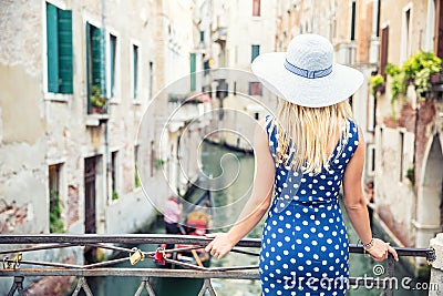 Happy young attractive woman fashion model of venice italy in blue polka dot outfit Stock Photo