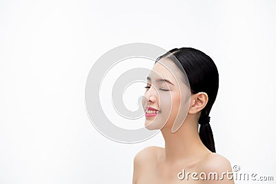 Happy young beautiful and elegant Asian woman in side view isolated over white background, Healthcare and Skincare concept. Stock Photo