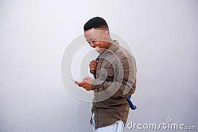 Happy young black man looking at cellphone Stock Photo