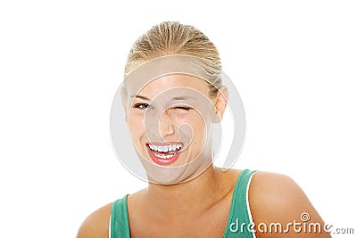 Happy young blond woman blinking. Stock Photo