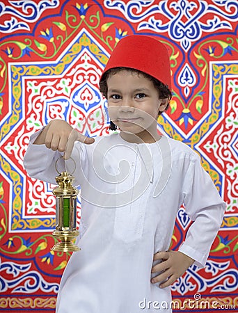 Happy Young Boy with Fez and Lantern Celebrating Ramadan Stock Photo