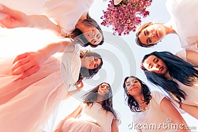 Happy young bridesmaids looking down together, bottom view Stock Photo