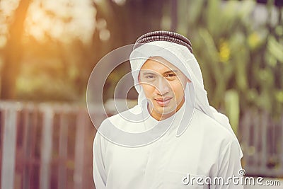 Happy young business arab middle eastern muslim man in garden Stock Photo