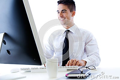 Happy young business man work in modern office on computer Stock Photo