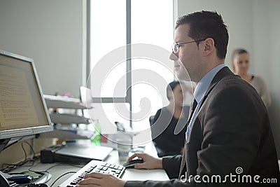 Happy young business man work in modern office.Handsome businessman in office.Real economist bussinesmen, not a model Stock Photo