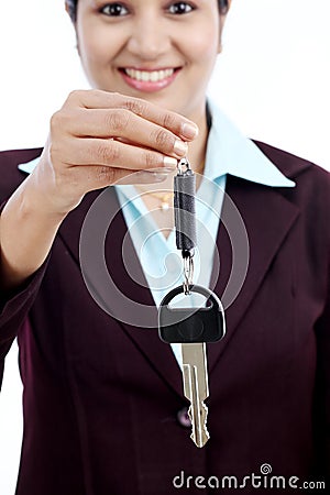 Happy young business woman holding key Stock Photo