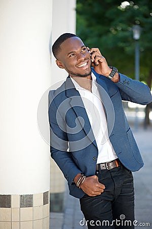 Happy young businessman calling with mobile phone Stock Photo