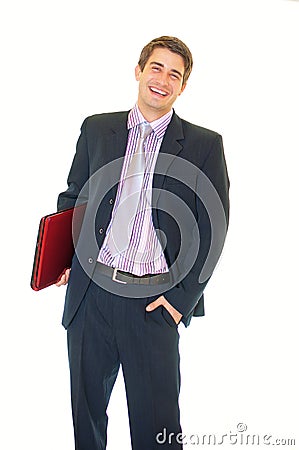 Happy young businessman holding laptop and smiling Stock Photo