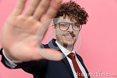 Happy young businessman in navy blue suit framing and smiling Stock Photo