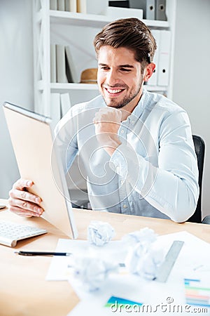 Happy young businessman reading notes in notpad Stock Photo