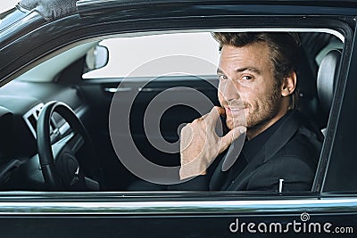 Happy young businessman traveling driving luxury car Stock Photo
